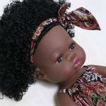 Bambola afro con bellissimi capelli e abito e fascia in stile africano