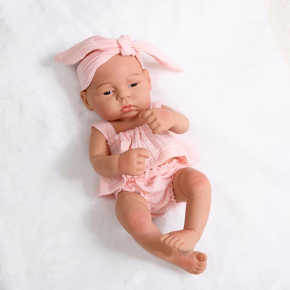 Bambola neonata in silicone per bambini con vestito rosa e fascia per capelli