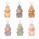 Peluche portachiavi kawaii stile labubu seduto in diversi colori su sfondo bianco